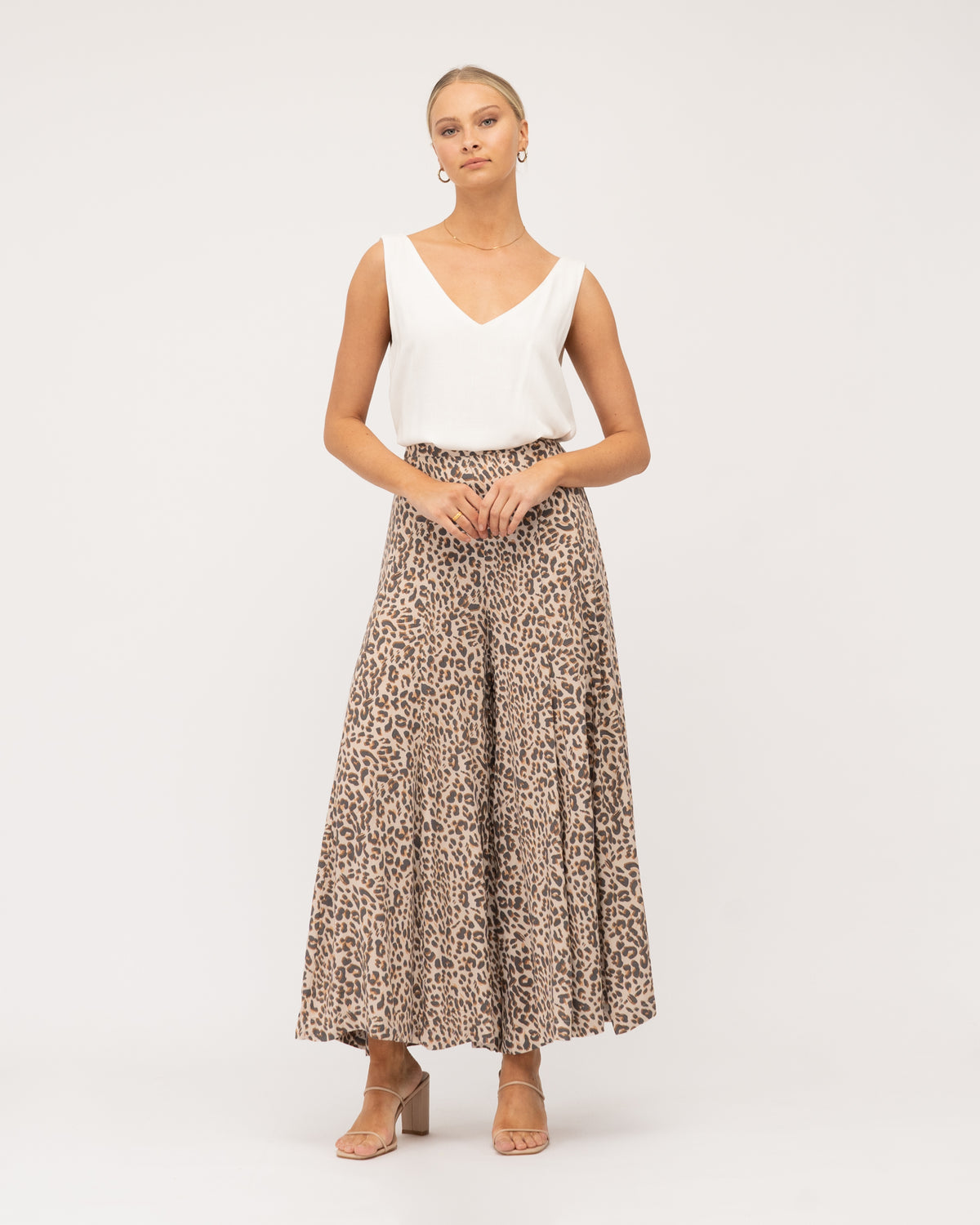 A model wearing animal print wide-leg pants featuring a flat front waistband, an elastic back waistband, and a wide leg design curated by Global Fashion House.