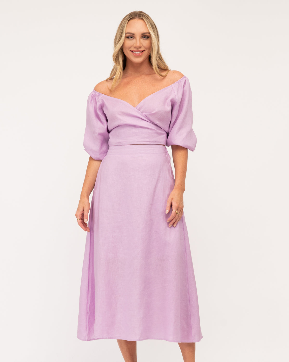 A girl wearing a purple linen maxi skirt with a matching top from the Ebby and I collection designed by Global Fashion House. 